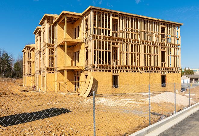 a close-up of temporary chain link fences enclosing a job site, signaling progress in the project's development in Commerce CA